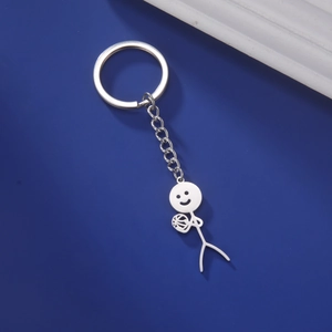 Macro detail of silver stainless steel keychain featuring a stickman hugging a volleyball