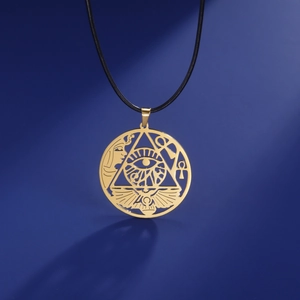 Detailed close-up of golden Egyptian Eye of Horus pendant with black cord on blue background