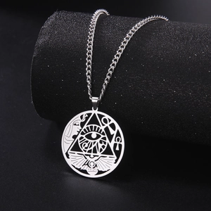 Detailed view of hollow Egyptian pendant with Eye of Horus and Ankh on black display