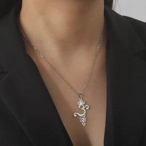 Elegant silver stainless steel necklace with lotus pendant on model in black suit