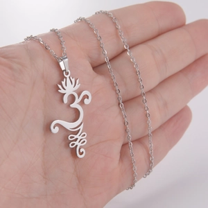 Minimalist silver lotus Om pendant necklace in stainless steel shown in hand for scale