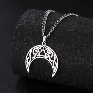 Detailed macro view of the Celtic knot moon and cat paw pendant in silver steel