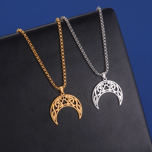 Macro shot of silver and gold crescent moon necklaces with cat paw detail on black leather