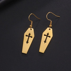 Detailed macro view of gold-plated coffin-shaped earrings with a hollow cross design
