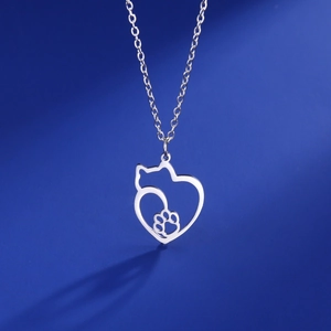 Macro shot of silver hollow cat and paw print pendant on fine link stainless steel chain