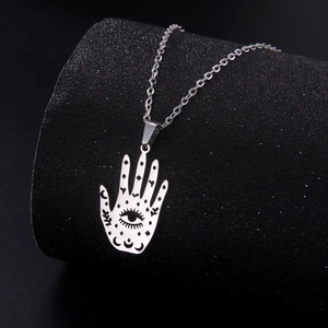 Minimalist stainless steel Hamsa Hand and moon hollow pendant necklace on black display