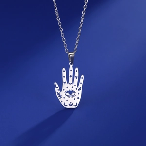 Macro shot of silver stainless steel Hamsa Hand pendant with moon and star cutout details