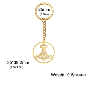 Close-up of golden stainless steel keychain with Thor Mjölnir pendant and Triquetra patterns
