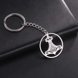 Detailed view of stainless steel Mjölnir keychain with Celtic knots on black leather