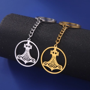 Detail view of gold and silver Viking Mjolnir keychains with intricate Nordic knots