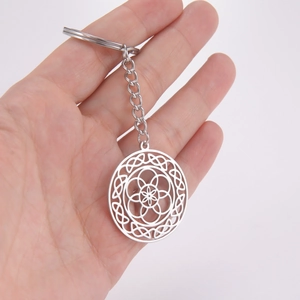 Polished stainless steel keychain featuring a hollow geometric flower of life pendant