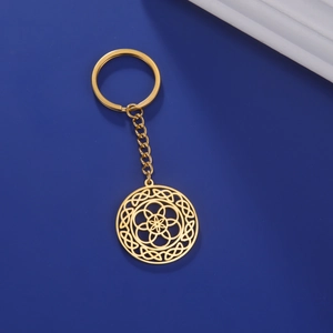 Close-up of golden stainless steel keychain with intricate hollow mandala flower pendant