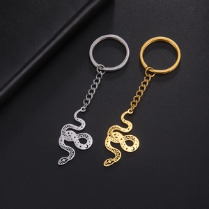 Detail of snake keychains with star and moon hollow patterns in gold and silver finish