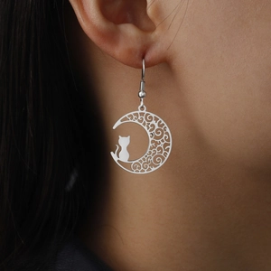 Detailed view of silver stainless steel earring featuring a hollow moon and cat pendant
