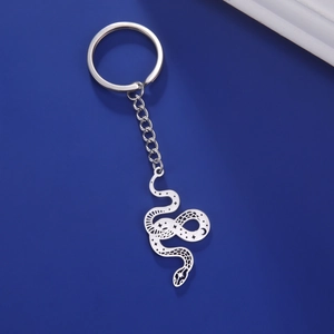 Macro shot of silver snake keychain pendant featuring intricate hollowed star and moon patterns
