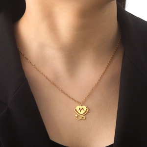 Elegant gold heart stethoscope necklace featuring an ECG design for medical professionals