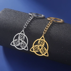 Detailed view of Celtic Triskele knot keychains in gold and silver stainless steel