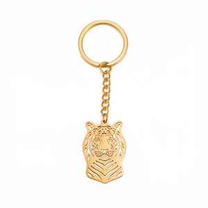 Porte-clés tête de lion doré en acier titane avec design punk évidé pour hommes et femmes