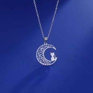 Detailed view of silver stainless steel crescent moon necklace with intricate cat silhouette