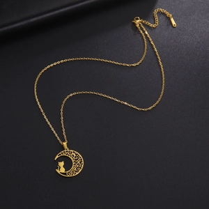 Close-up of golden crescent moon necklace with a cat silhouette on black leather