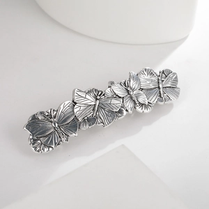 Detailed view of vintage silver alloy butterfly hair clip with intricate wing textures