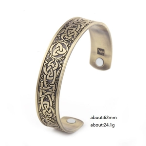 Vintage brass Viking cuff bracelet featuring Triquetra symbols and magnetic therapy elements