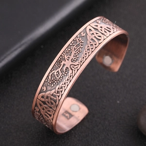 Detail of Celtic Knot and Tree of Life patterns on copper magnetic health bracelet
