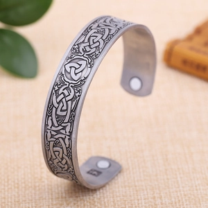 Detailed macro view of vintage silver Celtic knot engraved bracelet with magnetic ends