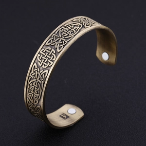 Detailed macro shot of vintage magnetic brass bracelet with Celtic knot patterns