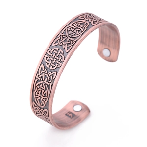 Vintage copper cuff bracelet with Celtic knot patterns and magnetic therapy stones