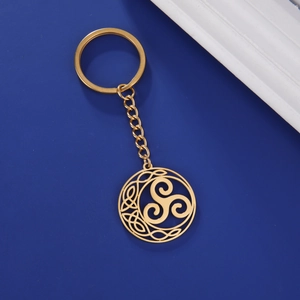 Detail of golden Triskele Celtic knot keychain with stainless steel chain and ring