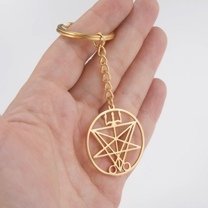 Gold stainless steel keychain featuring a circular geometric occult sigil pendant charm
