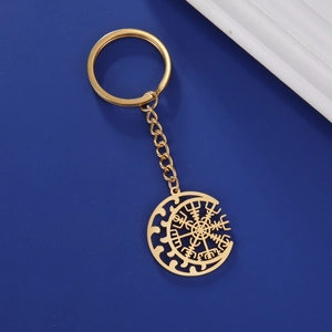 Macro detail of golden stainless steel key ring with Viking Vegvisir compass pendant