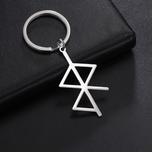 Close-up of silver stainless steel keychain with geometric runic lines on leather