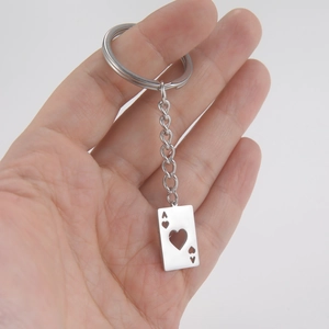 Polished stainless steel Ace of Hearts hollow pendant keychain held in hand for scale