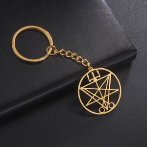 Close-up of gold stainless steel keychain with occult Sigil of Lucifer geometric pendant