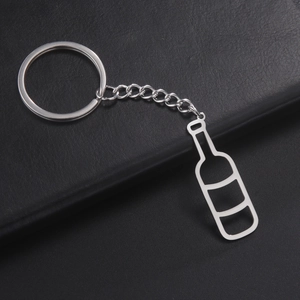 Polished stainless steel wine bottle keychain pendant on black leather surface