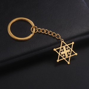 Detailed macro view of a golden Jerusalem Cross pendant with Hexagram frame on a black leather base