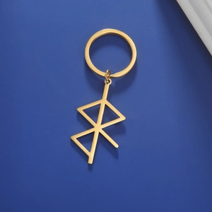 Detailed view of golden rune pendant keychain with polished stainless steel texture