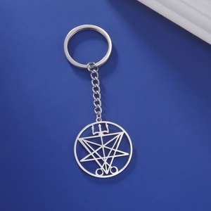 Macro detail of silver stainless steel keychain featuring the engraved Sigil of Lucifer