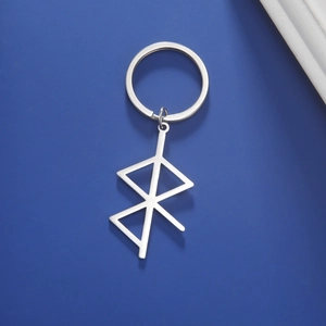 Macro detail of silver geometric Rune pendant on a stainless steel keychain ring