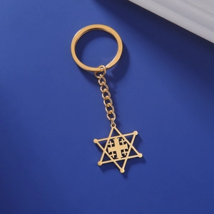 Detailed macro view of golden stainless steel Star of David and Cross pendant keychain