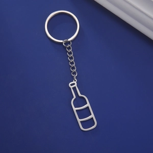 Detail of hollow wine bottle keychain with matte finish on deep blue background