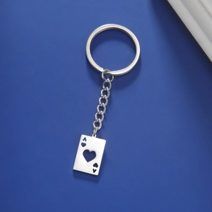Macro detail of silver stainless steel Ace of Hearts playing card keychain pendant
