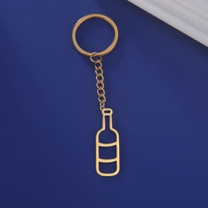 Detail of hollow wine bottle pendant keychain in polished gold-plated stainless steel