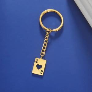 Detail of a golden stainless steel keychain featuring a hollow heart Ace of Hearts poker tag