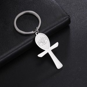 Close-up of polished stainless steel Ankh keychain with engraved lotus on black leather
