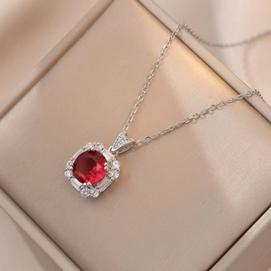 Elegant emerald-style ruby pendant necklace with vintage halo setting in velvet box
