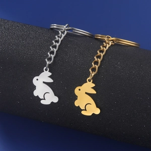 Cute stainless steel rabbit pendants in gold and silver finish hanging on a modern display