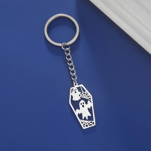 Detail of coffin-shaped keychain with ghosts and spiderweb cutout in silver steel